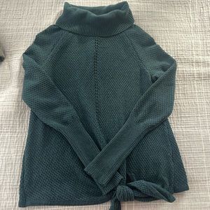 Never worn, green turtle neck sweater with tie detail. Size small.